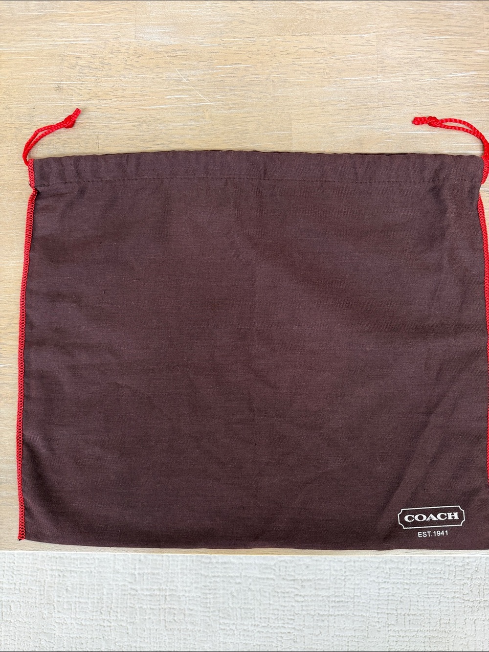 Coach 15.5” x 13.5” dust bag, brown with red edging and white lettering